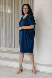 A model wearing the Original Miracle Dress in colour Navy (Blue), from the front, showing the whole outfit