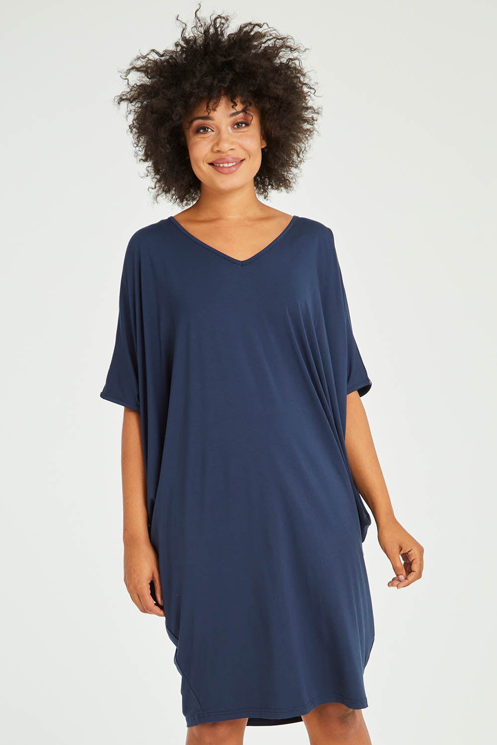 Model Olivia wearing size OneSize of the Original Miracle Dress in colour Navy (Blue), from the front, cropped image