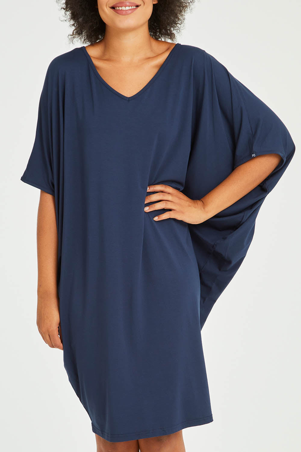 Model Olivia wearing size OneSize of the Original Miracle Dress in colour Navy (Blue), from the front, cropped image