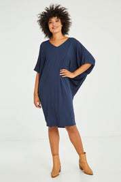 Model Olivia wearing size OneSize of the Original Miracle Dress in colour Navy (Blue), from the front, showing the whole outfit