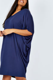 Model Shanaya wearing size OneSize of the Original Miracle Dress in colour Navy (Blue), from the front, cropped image