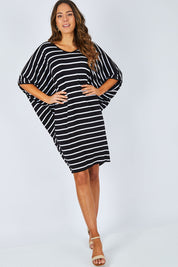 Model Madeline wearing size OneSize of the Stripe Original Miracle Dress in colour BlackWhite (Black), from the front, showing the whole outfit