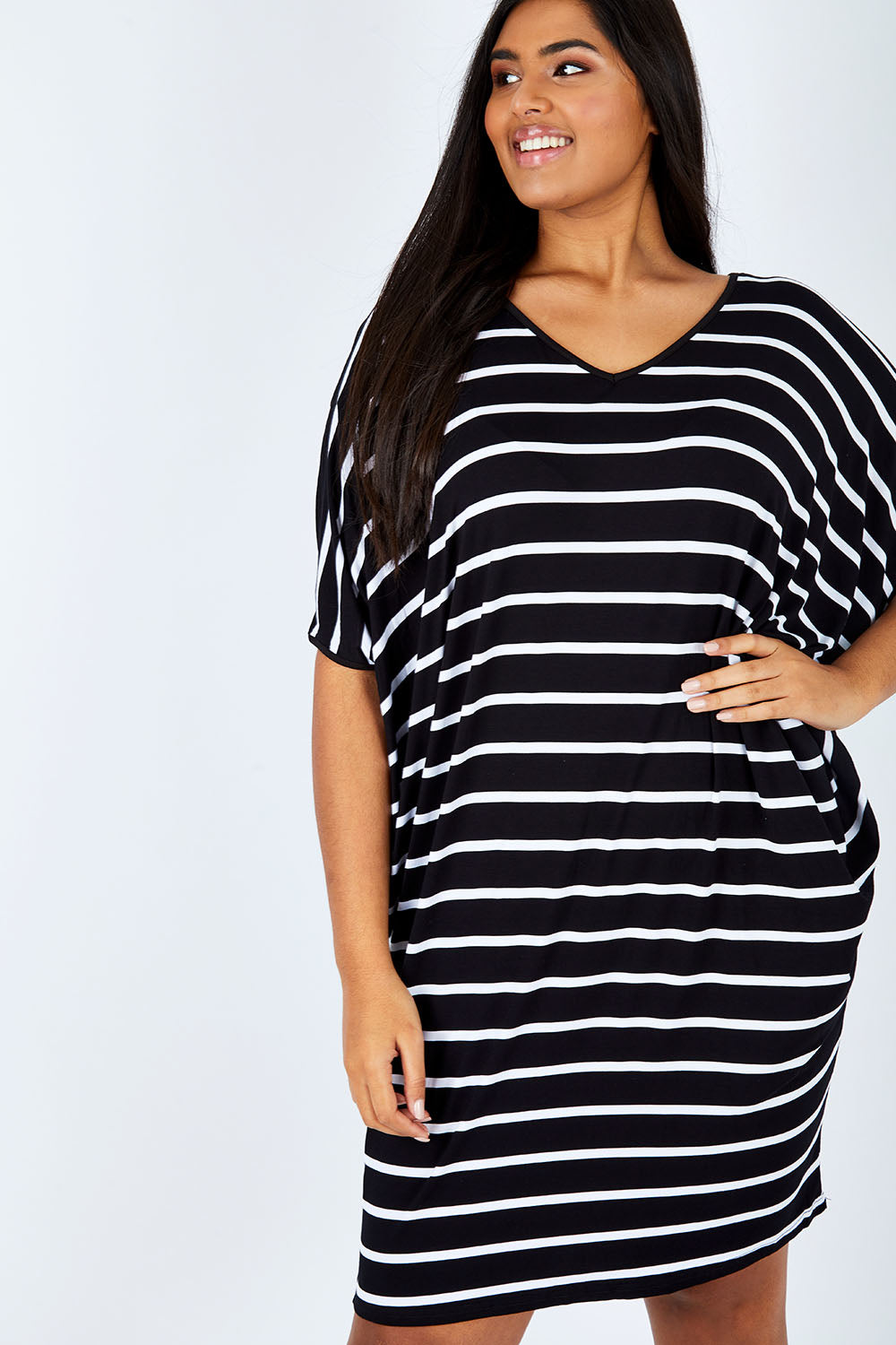 Model Shanaya wearing size OneSize of the Stripe Original Miracle Dress in colour BlackWhite (Black), from the front, cropped image