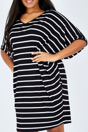 Model Shanaya wearing size OneSize of the Stripe Original Miracle Dress in colour BlackWhite (Black), from the front, cropped image