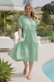 A model wearing the Roamer Tencel Blend Dress in colour Caribbean (Green), from the front, showing the whole outfit
