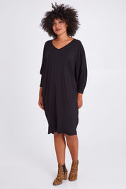 Model Olivia wearing size OneSize of the Long Sleeve Miracle Dress in colour Black (Black), from the front, showing the whole outfit