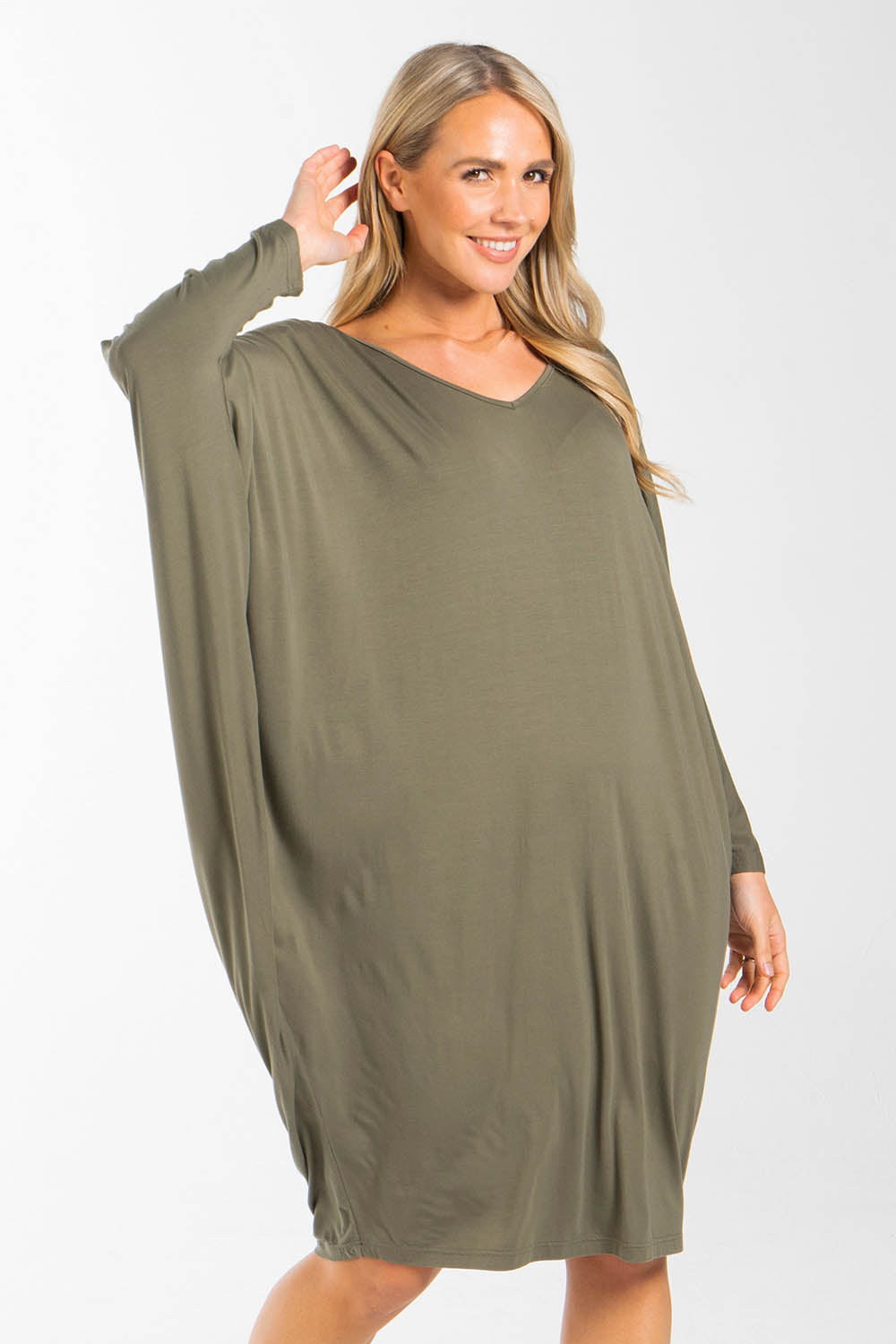 A model wearing the Long Sleeve Miracle Dress in colour Khaki (Green), from the front, cropped image