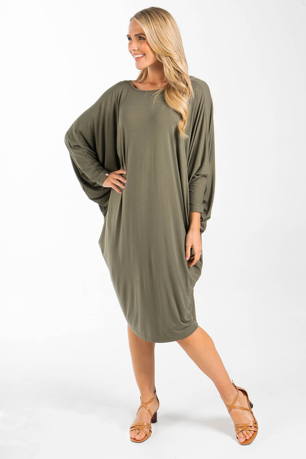 A model wearing the Long Sleeve Miracle Dress in colour Khaki (Green), from the front, showing the whole outfit