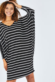 Model Summer wearing size OneSize of the Long Sleeve Stripe Miracle Dress in colour BlackWhite (Black), from the front, cropped image