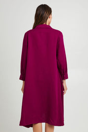 Model Madeline wearing the Cadillia Dress in colour Deepplum (Pink), from the back