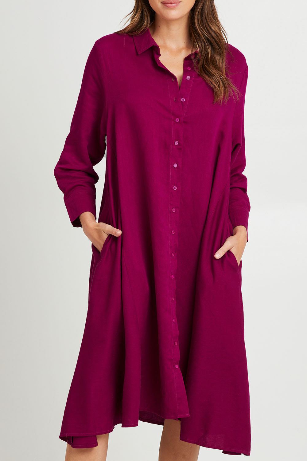 Model Madeline wearing the Cadillia Dress in colour Deepplum (Pink), from the front, cropped image