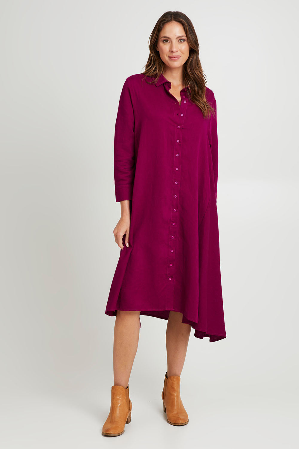 Model Madeline wearing the Cadillia Dress in colour Deepplum (Pink), from the front, showing the whole outfit