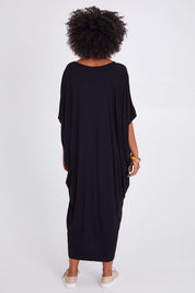 Model Olivia wearing size OneSize of the Maxi Miracle Dress in colour Black (Black), from the back