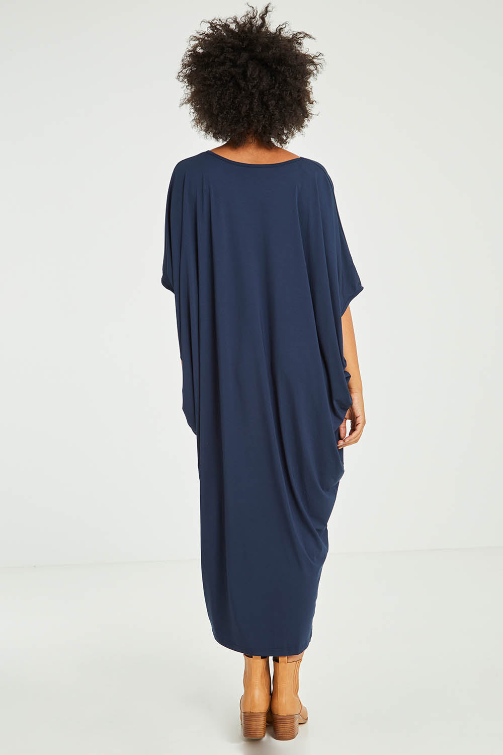 Model Olivia wearing size OneSize of the Maxi Miracle Dress in colour Navy (Blue), from the back