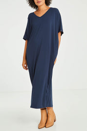 Model Olivia wearing size OneSize of the Maxi Miracle Dress in colour Navy (Blue), from the front, cropped image