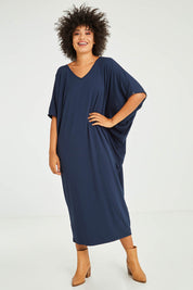 Model Olivia wearing size OneSize of the Maxi Miracle Dress in colour Navy (Blue), from the front, showing the whole outfit