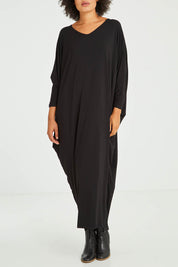 Model Olivia wearing size OneSize of the Long Sleeve Maxi Miracle Dress in colour Black (Black), from the front, cropped image