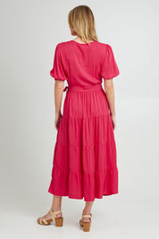 Model Grace wearing the Ruffle Wrap Dress in colour Pink (Pink), from the back
