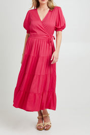 Model Grace wearing the Ruffle Wrap Dress in colour Pink (Pink), from the front, cropped image