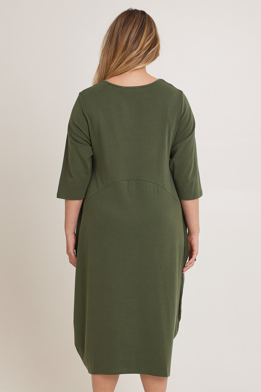 Model Chanel wearing the Alviva Lounge Dress in colour Fern (Green), from the back