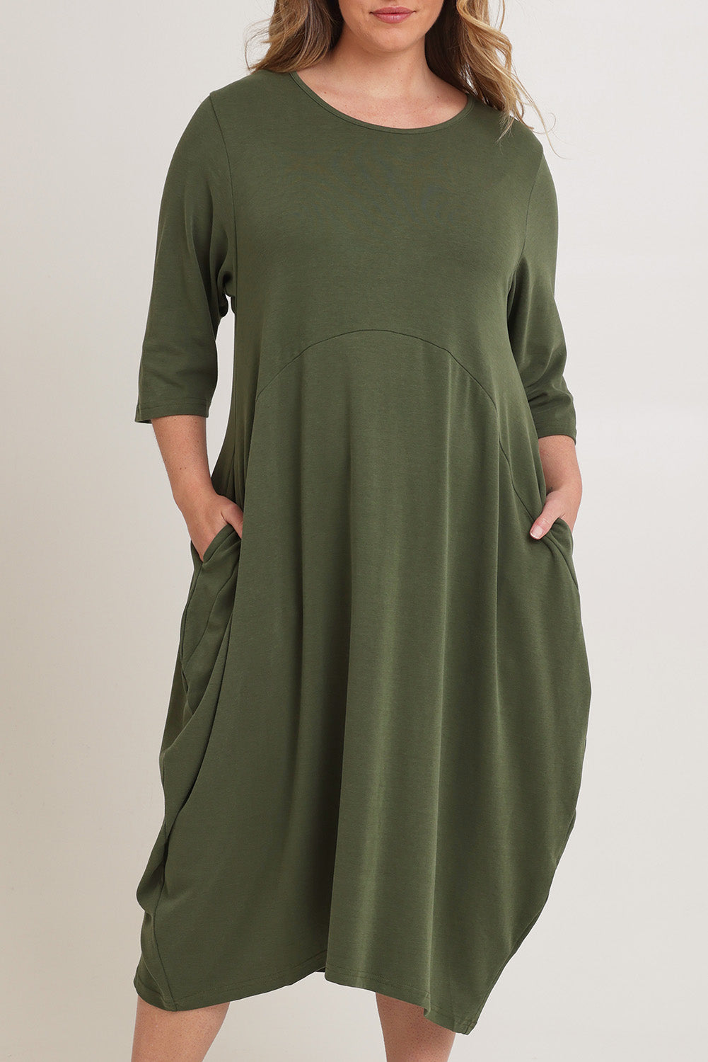 Model Chanel wearing the Alviva Lounge Dress in colour Fern (Green), from the front, cropped image