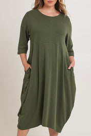 Model Chanel wearing the Alviva Lounge Dress in colour Fern (Green), from the front, cropped image