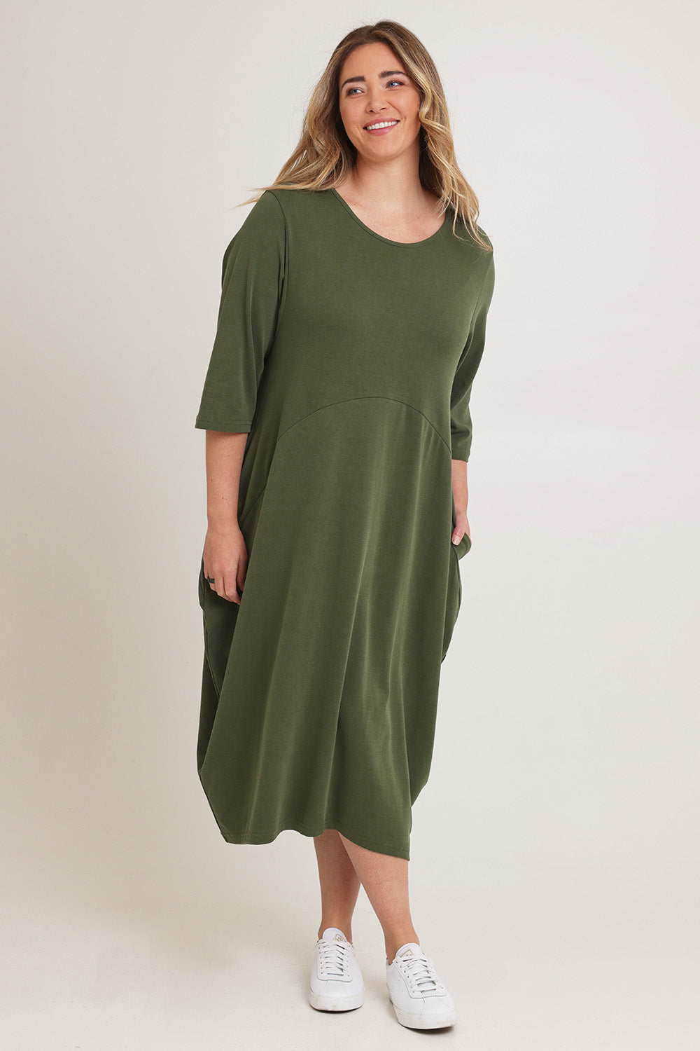Model Chanel wearing the Alviva Lounge Dress in colour Fern (Green), from the front, showing the whole outfit