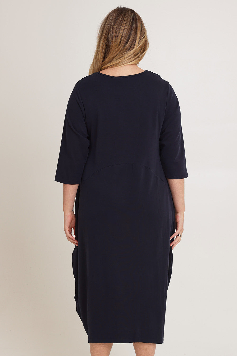 Model Chanel wearing the Alviva Lounge Dress in colour Navy (Blue), from the back