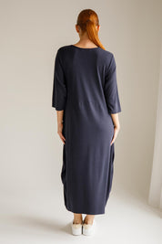 A model wearing the Alviva Lounge Dress in colour Navy (Blue), from the back