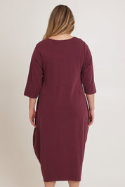 Model Chanel wearing the Alviva Lounge Dress in colour Shiraz (Purple), from the back