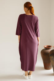 A model wearing the Alviva Lounge Dress in colour Shiraz (Purple), from the back