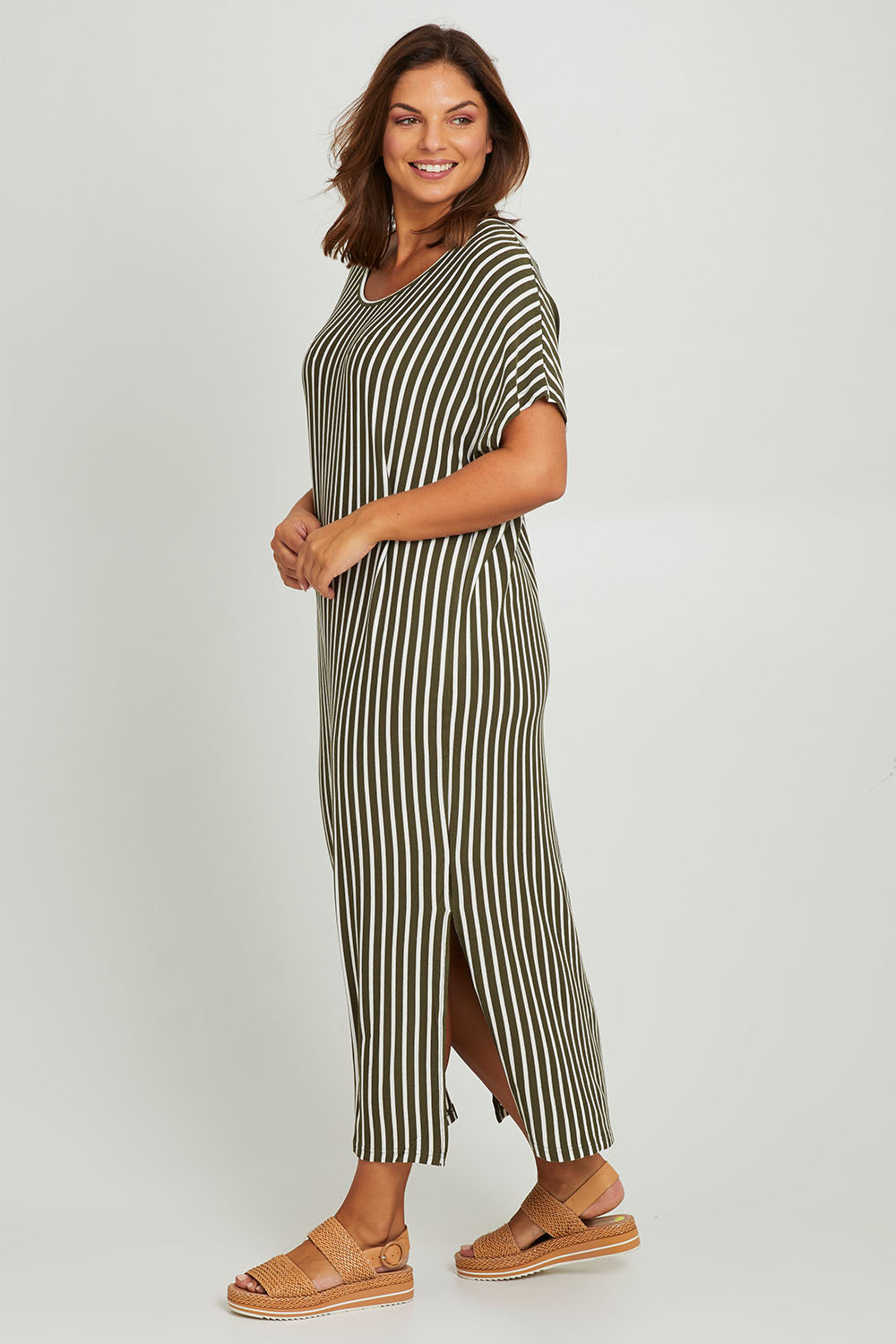 Model Monique wearing the Destiny Dress in colour Green (Green), from the front, showing the whole outfit