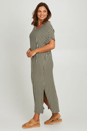 Model Monique wearing the Destiny Dress in colour Green (Green), from the front, showing the whole outfit