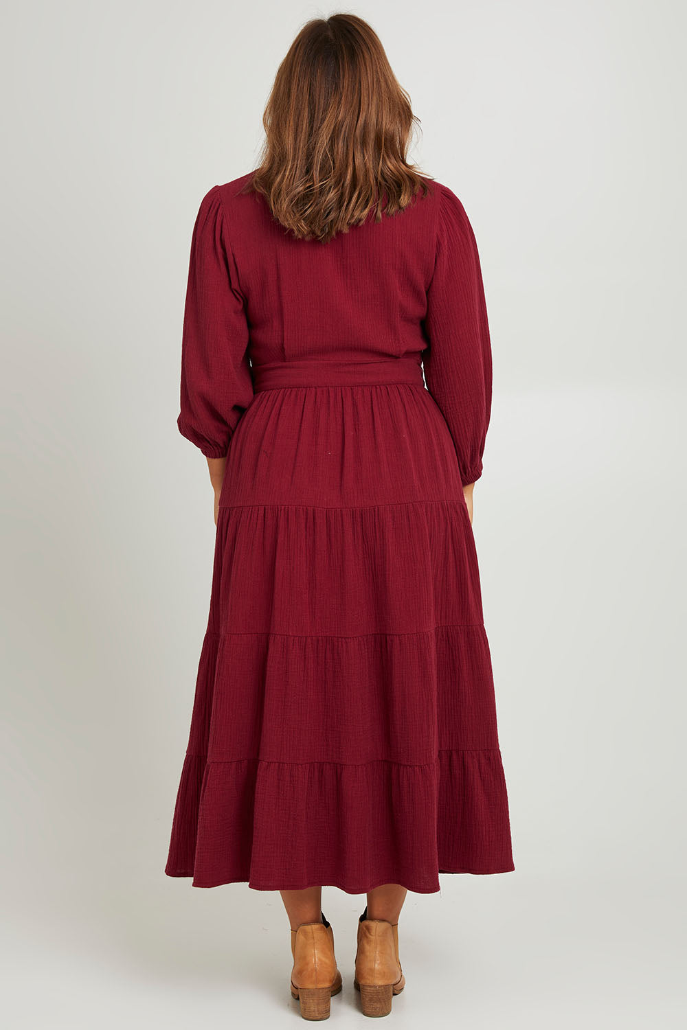 Model Monique wearing size L of the L/S Ruffle Wrap Dress in colour Mahogany (Pink), from the back