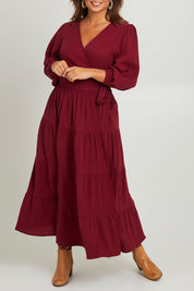 Model Monique wearing size L of the L/S Ruffle Wrap Dress in colour Mahogany (Pink), from the front, cropped image