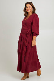Model Monique wearing size L of the L/S Ruffle Wrap Dress in colour Mahogany (Pink), from the front, showing the whole outfit