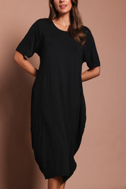 Model Madeline wearing the Soho S/S Dress in colour Black (Black), from the front, cropped image