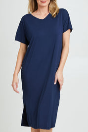 Model Grace wearing the Fate V Neck Dress in colour Navy (Blue), from the front, cropped image
