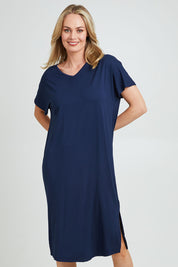 Model Grace wearing the Fate V Neck Dress in colour Navy (Blue), from the front, cropped image