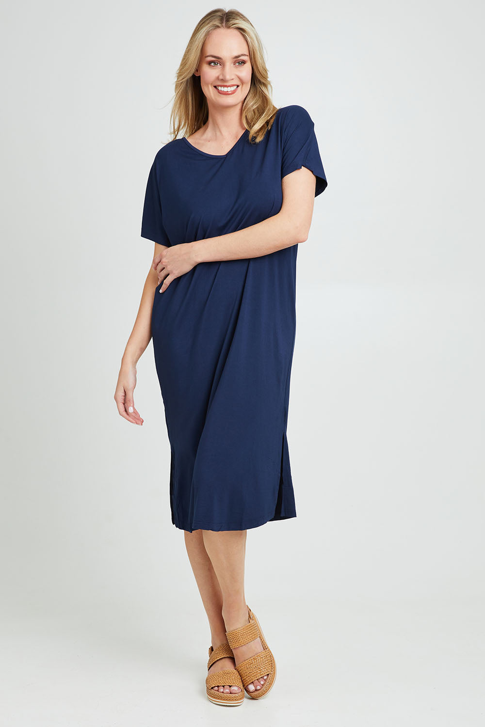 Model Grace wearing the Fate V Neck Dress in colour Navy (Blue), from the front, showing the whole outfit