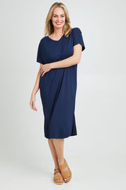 Model Grace wearing the Fate V Neck Dress in colour Navy (Blue), from the front, showing the whole outfit