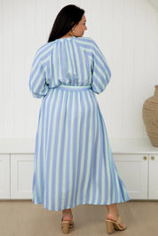 A model wearing the Athena Tencel Dress in colour Blue (Blue), from the back