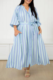 A model wearing the Athena Tencel Dress in colour Blue (Blue), from the front, cropped image