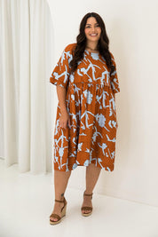 A model wearing the Kingsley Cotton Dress in colour Myrtle, from the front, showing the whole outfit