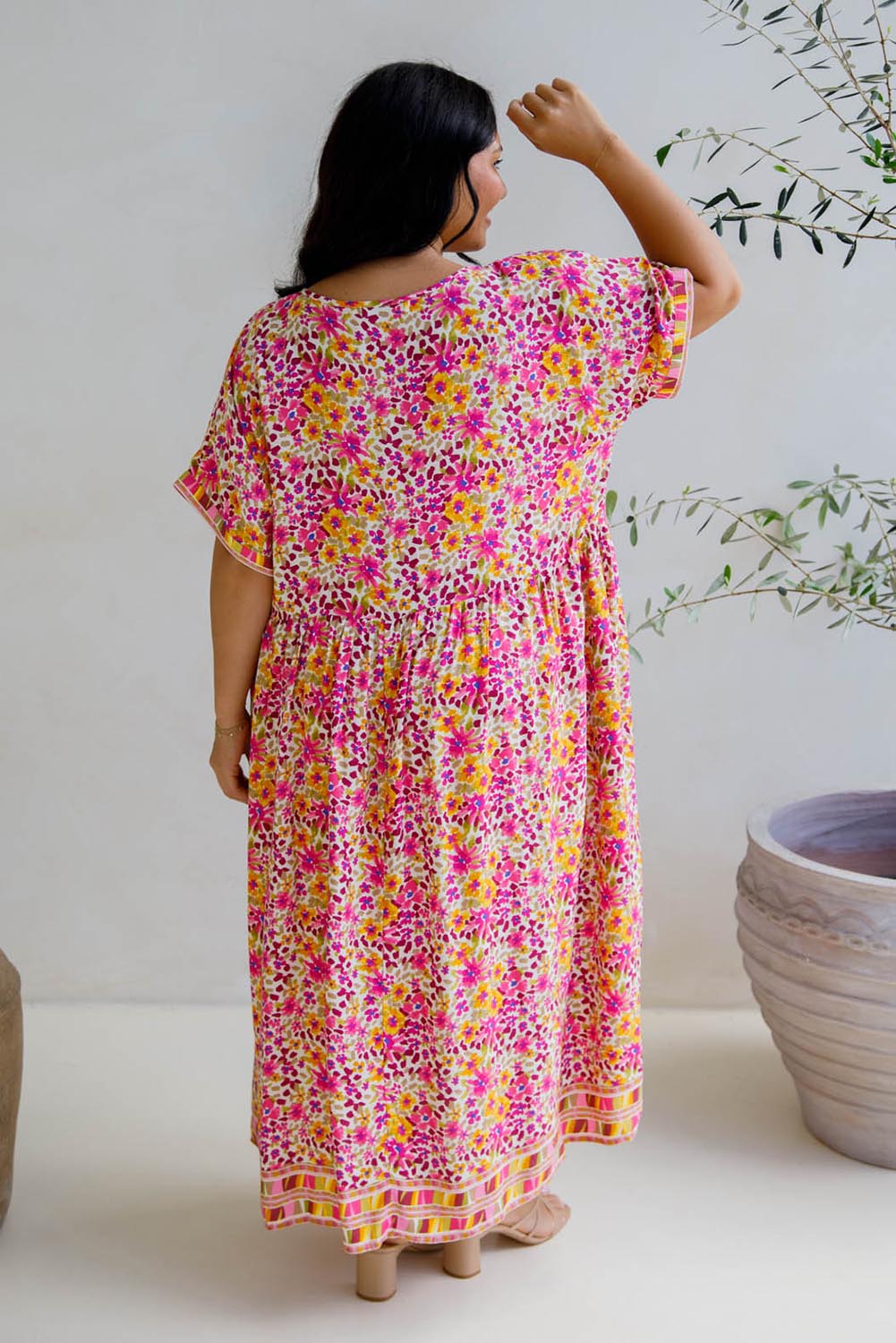 A model wearing the Frolic Dress in colour Harmony, from the back