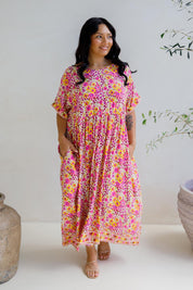 A model wearing the Frolic Dress in colour Harmony, from the front, showing the whole outfit