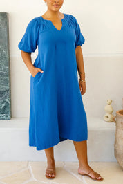 A model wearing the Novella Cotton Dress in colour Ultramarin (Blue), from the front, cropped image