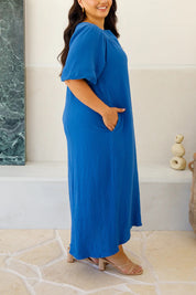 A model wearing the Novella Cotton Dress in colour Ultramarin (Blue), from the front, cropped image