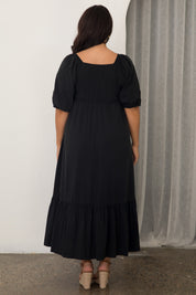 A model wearing the Austin Midi Tencel Blend Dress in colour Black (Black), from the back