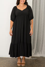 A model wearing the Austin Midi Tencel Blend Dress in colour Black (Black), from the front, cropped image